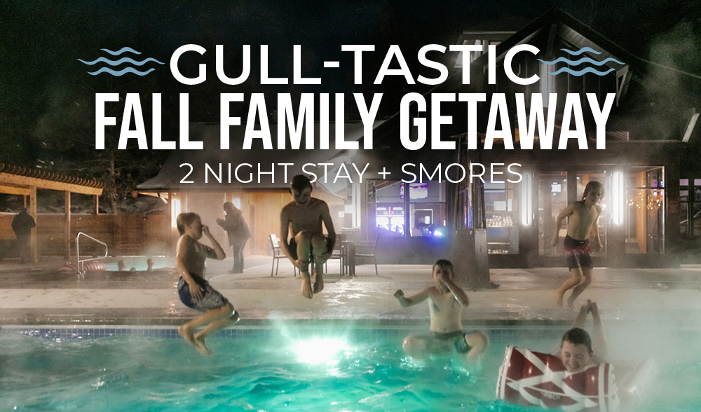 Children jumping into a steaming pool at night