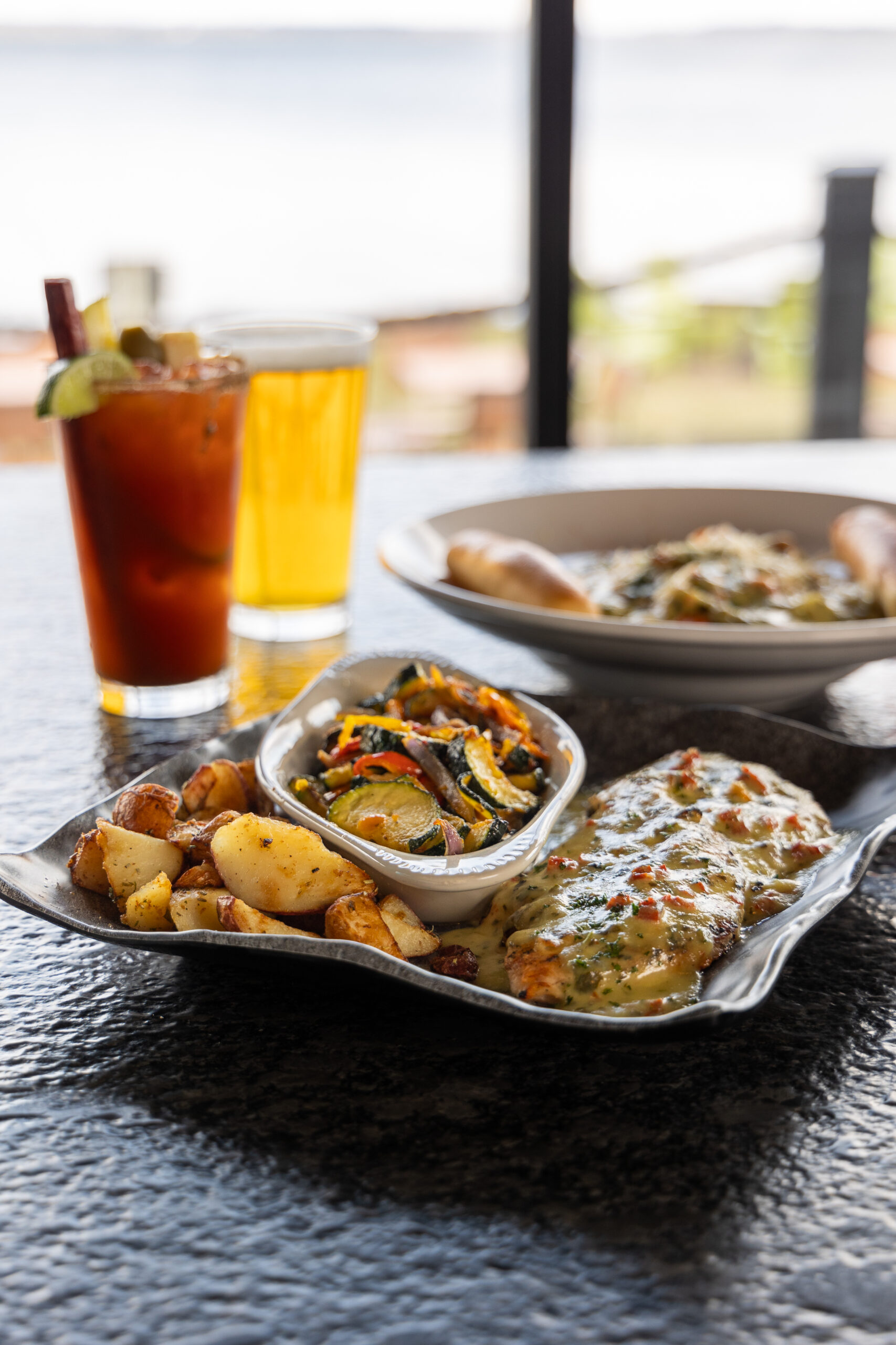 Grilled chicken with vegetables, potatoes, and drinks