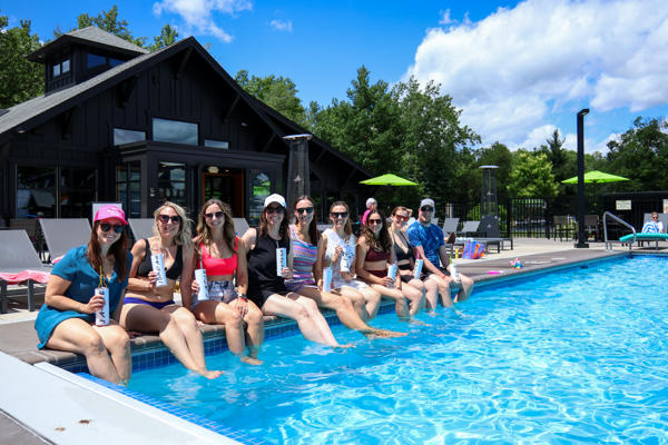 Group of women relaxing by sunny poolside