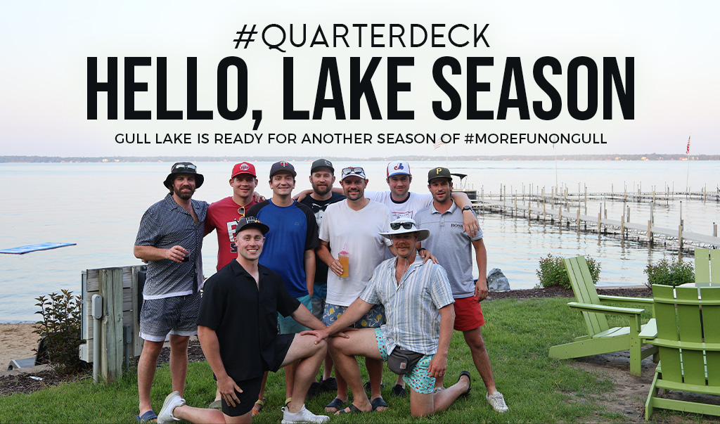 Group of men posing by lakeside dock