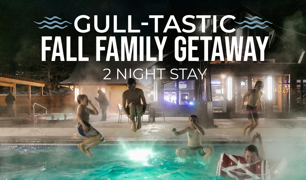 Children jumping into a steaming pool at night